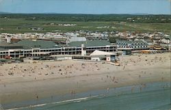 Bird's eye view of Hampton Beach, casino, facilities building, school bus, bathers Postcard