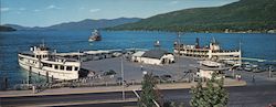 Scenic Lake George, MV Ticonderoga and MV Mohican docked, SS Minne-Ha-Ha paddle wheel steamboat Large Format Postcard
