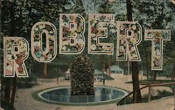 Name "Robert" in large floral letters, woods and fountain in background Postcard