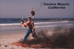 Venice Beach, California. Man juggling chain saws on the beach.