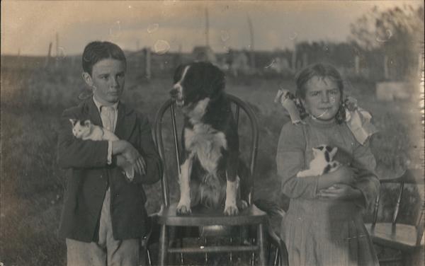 Spaniel on a Chair, Flanked by a Boy and Girl Holding Kittens