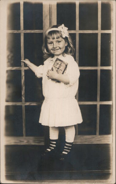 Happy Little Girl Poses with Book Children
