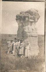 People Posing Next to Cowboy Rock Postcard
