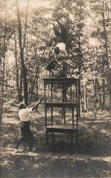 Handstand on Back Legs of Two Chairs, and Three Stacked Piano Benches Postcard