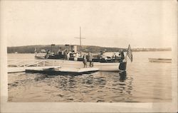 Docked boat with passengers and an American flag Postcard