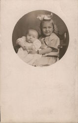 Little Girl Holding Baby Postcard
