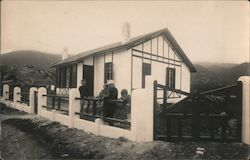 House with Fence and Gate Woman and Three Children Postcard