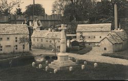Historical outdoor photo, two men and miniature village approximately 1/6 scale Postcard