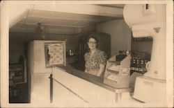 Female Store Clerk Behind the Counter Postcard