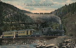 Train on tracks, Two miles around to gain 200 feet between Lead and Deadwood Postcard