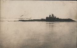 6 people sitting on rocks near water Postcard