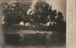 View of Cottage, rowboats Postcard