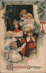 Christmas Greetings - Kids gathered around Christmas Cake Postcard