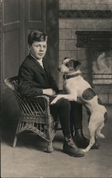 Boy and Dog Sit in Front of Fireplace Postcard