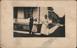 Family photo in front of the house Postcard