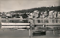 Majorca Boat on Lake with Town in Background Postcard