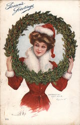 Season's Greetings - A Woman in a Santa Hat with a Wreath Postcard