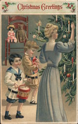 Christmas Greetings - A Woman and Two Children Decorating a Tree Postcard