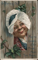 St. Patrick's Day. Smiling face wearing hat. "May the Corners of Yer Mouth Niver Turn Down." Postcard