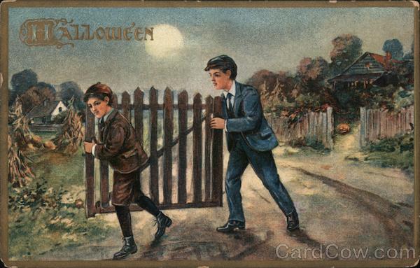 2 boys walking with a wooden gate. Halloween