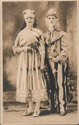 Couple in Patriotic Costumes, Masks, Uncle Sam Postcard