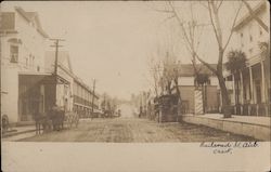 Street with Shops and Horse-Drawn Wagon Postcard