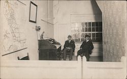 Two Men Sitting in Front of Desk in Office Postcard