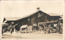 House with a Couple Standing in Front Postcard