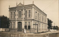 I.O.O.F. Hall Woman Standing in Front Next to a Bicycle Postcard