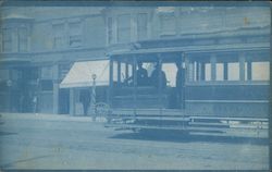 Street Car in Front of Store Buildings Postcard
