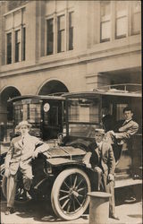 Four Men Sitting on a Car Postcard