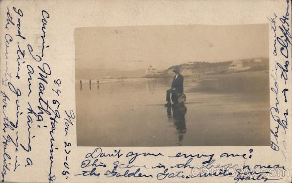 Cliff House A Man Sitting on a Barrel on the Beach San Francisco California