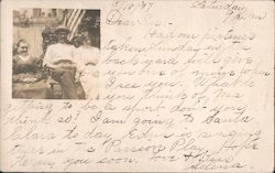 A Man and Two Women Sitting in a Yard Postcard