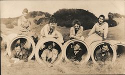 People Laying In and On Top of Concrete Pipes Postcard