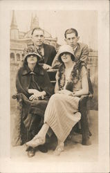 Two Men and Two Women Posing for a Photo Postcard