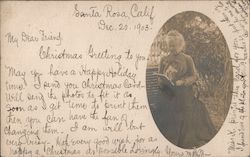 A Woman Sitting on a Bench Reading a Book Postcard