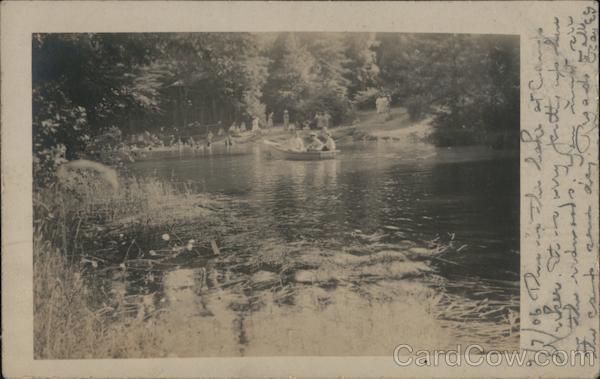 Three people in small boat on river Camp Meeker California