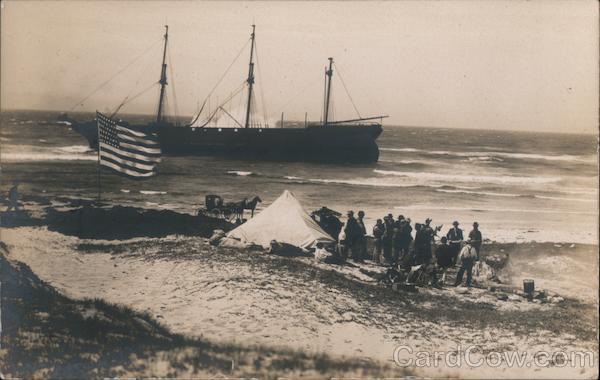 A Group of People on the Beach with a Large Ship in the Water Pacific Grove California