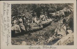 Women and others riding log being pulled by oxen Postcard