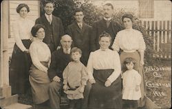 A Family Posing in Front of a House - Christmas 1910 Postcard