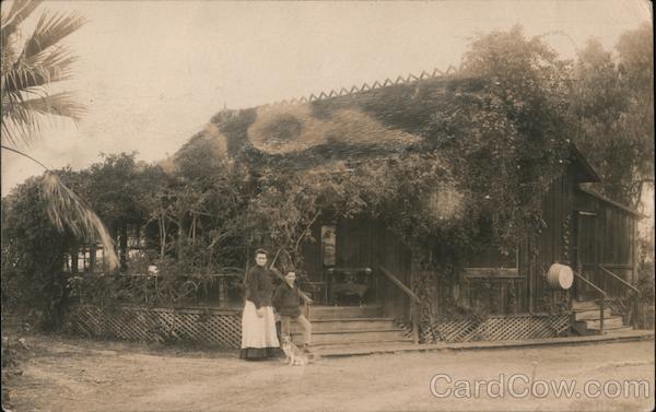A Woman, Boy and Dog Standing in Front of a Building Guerneville California