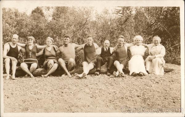 Nine People Sitting on a Log with Their Arms Around Each Other Guerneville California