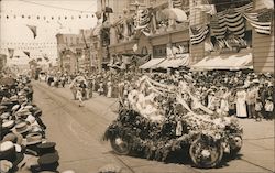 A Military Parade On A Street Full Of People and A Car Is Heavily Decorated Postcard