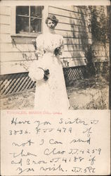 A Woman Holding her Hat Standing Next to a House Tomales, CA Postcard Postcard Postcard