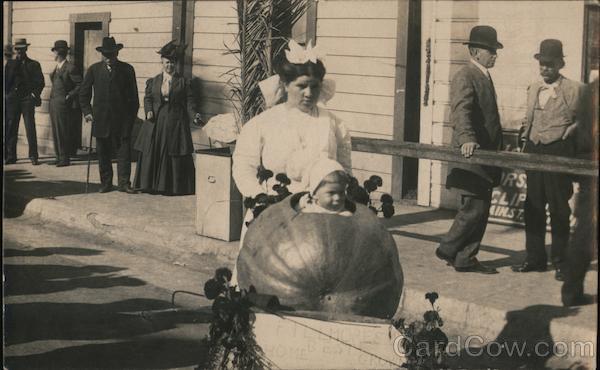 A Woman Pushing a Child in a Large Pumpkin Ventura California