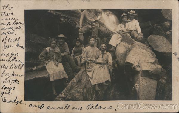 Three couples with small boy and single man posing at a waterfall Pala California