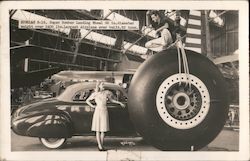 Wheel of a Douglas B-19 Next to a Car Postcard