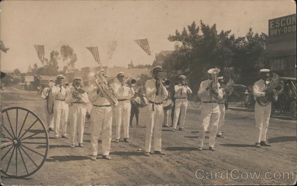 Marching Band walking down street dressed in white for parade Chico California