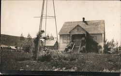 House with bottom of a windmill showing Postcard