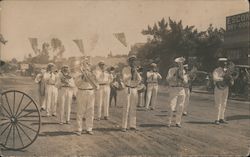 Marching Band walking down street dressed in white for parade Postcard